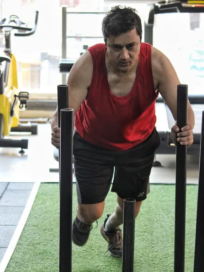 No matter your starting point, the work is the same. This client is giving his all on the sled push, a challenging but effective conditioning exercise.