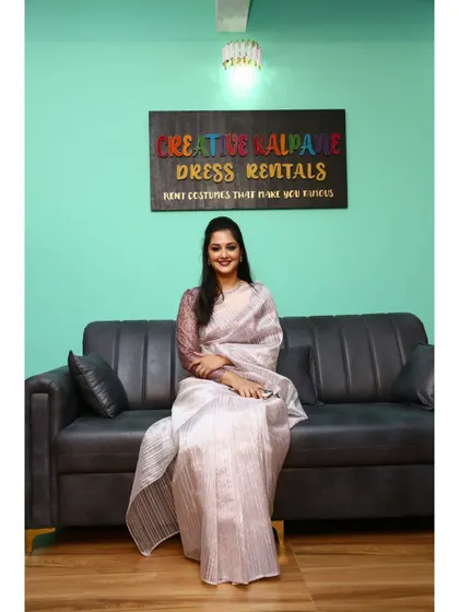 This shot clearly shows our comfortable grey sofa and the mint green wall, which features our studio's logo. It's a great spot for modern portraits.