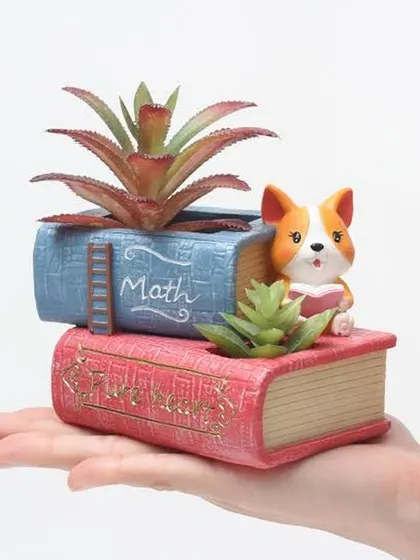 A perfect gift for a student or anyone who loves to read. This resin planter is shaped like a stack of books with a cute dog, and has two spots for planting small succulents.