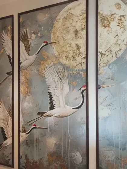 This triptych-style mural shows cranes in flight against the moon. I install these multi-panel designs with precision to ensure the image flows correctly across the frames.