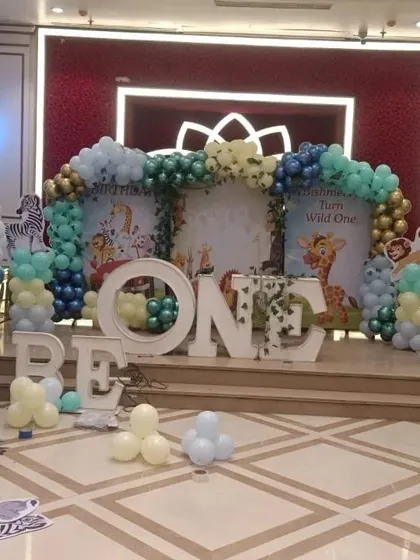 A behind-the-scenes look at a "Wild One" jungle theme setup in progress. You can see the animal cutouts and balloon pillars coming together to create a safari adventure.