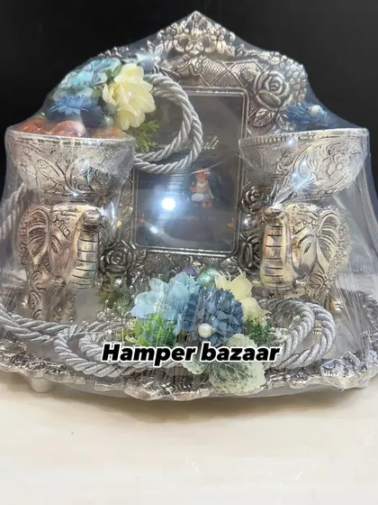 Our German silver platter hamper is a statement of pure elegance. It features two elephant-shaped bowls for dry fruits and a photo frame, making it a luxurious and reusable gift for Diwali or weddings.