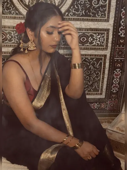 A moody shot from my retro-inspired photoshoot. The combination of the black saree, red blouse, and dramatic smokey atmosphere creates a timeless and powerful image.