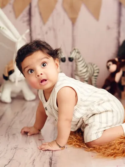 On the move. This little explorer is crawling through a jungle of his favorite stuffed animals. It's a great way to show scale and personality.