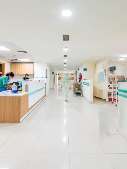 This view of a busy nursing station and ward shows a space designed for high efficiency. The layout is clean and organized, with durable, easy-to-clean surfaces, ensuring a safe and functional environment for delivering care.