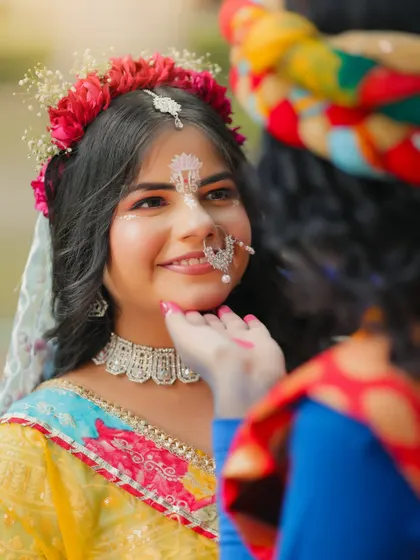 A close-up that captures a tender moment, highlighting the delicate facial expressions and makeup.