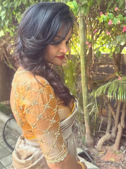 Another view of the gold blouse, showing how the back design looks from the side. It's a subtle detail that adds a lot of charm.