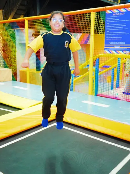 Another happy student mid-jump. The open trampoline area allows kids to bounce freely and safely.