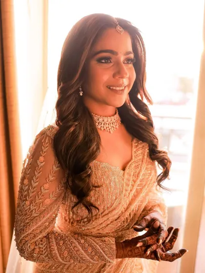 A sun-kissed shot of a beautiful client, with the light catching her glowing makeup perfectly.