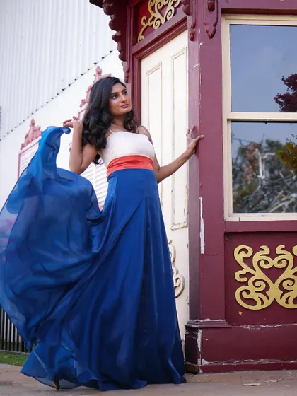 Radiant in my bespoke designer dress, my client shines brightly during her enchanting pre-wedding shoot. The flowing blue satin skirt creates a beautiful sense of movement.