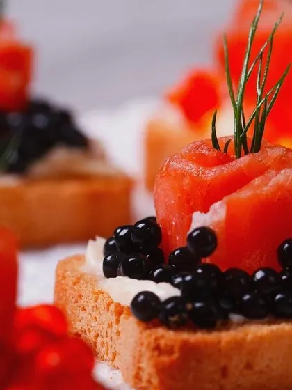 Attention to detail is paramount. These canapés feature smoked salmon rosettes topped with caviar, a small bite that delivers a powerful statement of luxury and quality for high-end corporate functions.
