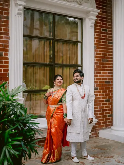 A classic portrait of the couple standing together, showcasing their elegant wedding attire.