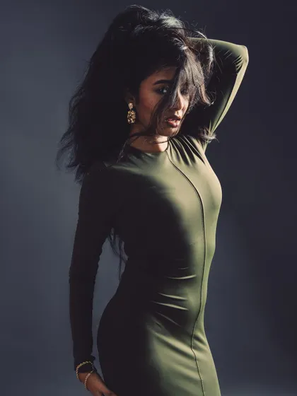 A mysterious and moody shot. The hair obscuring the face creates intrigue and focuses attention on the form and silhouette.