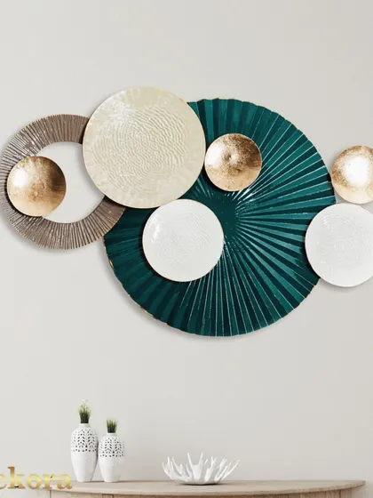 A contemporary wall sculpture combining a large, textured green fan with smooth white and gold discs. The contrast in textures and shapes makes this a unique piece of abstract art.