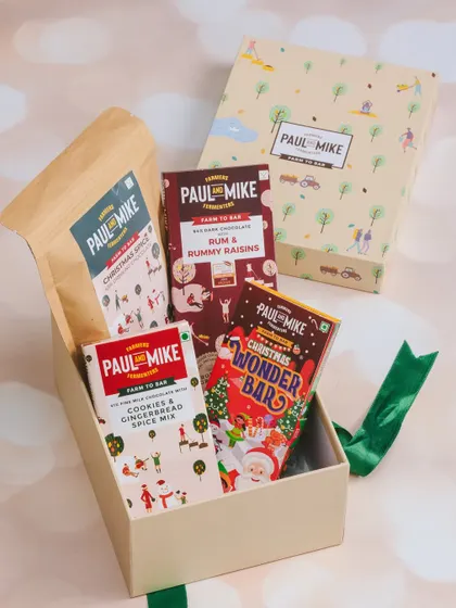 A flatlay of a Christmas chocolate gift box, showcasing the variety of products inside with a clean and bright aesthetic.