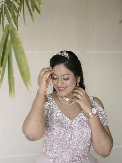 A happy, smiling bride. The makeup is designed to enhance her joy, with a focus on radiant skin and eyes that shine.