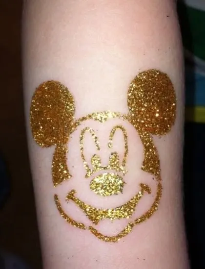 The iconic Mickey Mouse head in sparkling gold glitter. This classic character design is a fun and recognizable choice for Disney fans of all ages.