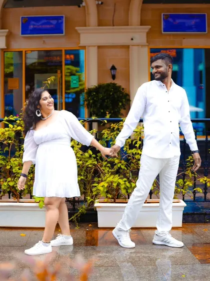 A happy, casual pre-wedding photo of a couple walking hand-in-hand in the city. These lifestyle shots are great for capturing your everyday love story.