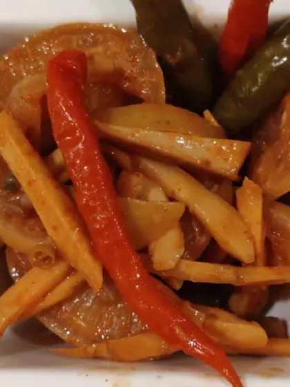A close-up of our mixed pickle. You can see pieces of turnip, carrot, and chillies, all coated in a thick, spicy masala.