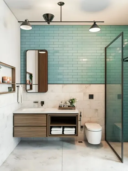 I used a beautiful sea-green subway tile as an accent wall in this bathroom. Paired with a floating wood vanity, it creates a fresh and contemporary feel.