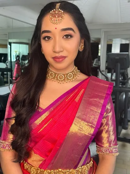 The complete look for the Ganesh Pooja, with a classic half-up hairstyle and radiant makeup.