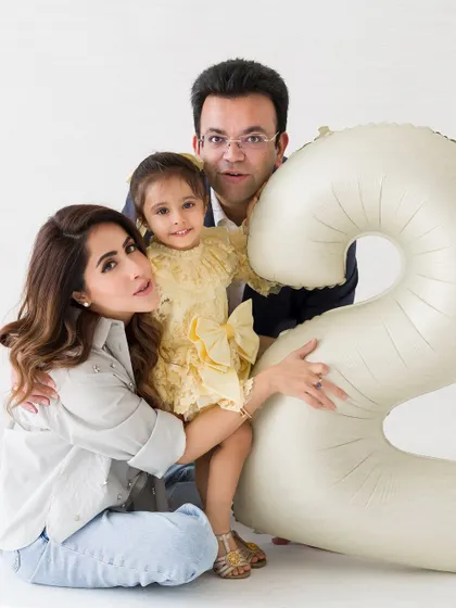 A loving family portrait from a second birthday session. The family huddles together, creating a warm and intimate memory.