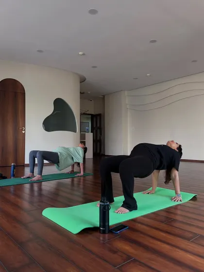 A student demonstrates strength and openness in Purvottanasana, the Upward Plank Pose. This posture helps to open the chest and shoulders while building strength in the arms and back.