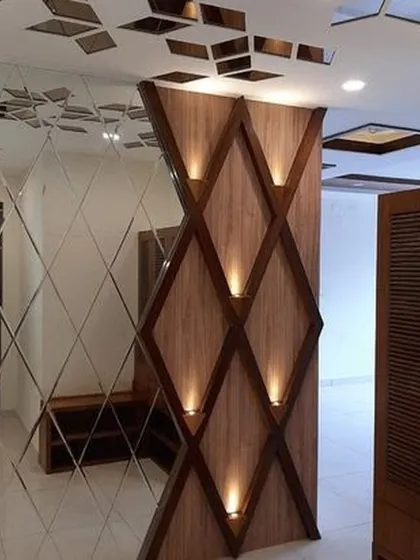 A stunning decorative partition featuring a diamond-patterned wooden structure with built-in accent lights. Paired with a fully mirrored wall, this design element adds a touch of glamour and drama to the entryway.