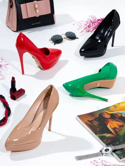 This vibrant group shot captures the fun and variety of a women's heel collection. I arranged the shoes with complementary accessories like lipstick and sunglasses to create a complete fashion story that feels energetic and ready for a night out.
