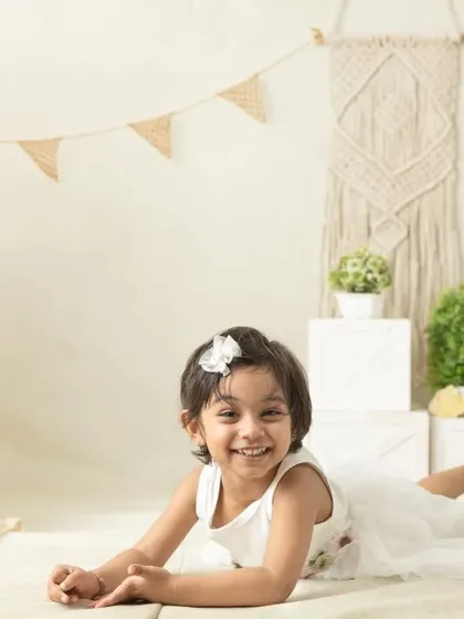 My boho-themed sessions use natural textures like macrame, wood, and greenery to create a calm and earthy setting that beautifully complements your child's simple joy.