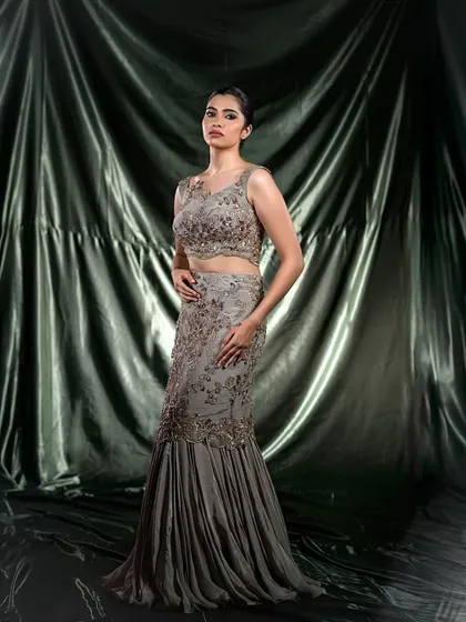 A full-length shot of the mermaid-style grey gown, demonstrating a high-fashion look.