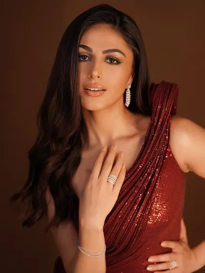 A final look at the stunning details of this red gown. The soft, romantic glow of the fabric paired with delicate diamond jewelry creates a look of pure glamour and sophistication.