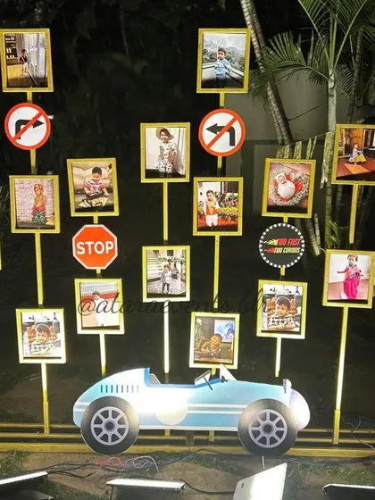 A personalized photo gallery showcases the birthday boy's first years, with each picture frame attached to a stand featuring road signs like "Stop" and "No Left Turn".