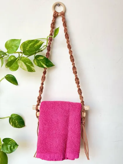 A simple and stylish macrame towel holder. This is a great way to add a touch of handmade charm to your bathroom or kitchen.