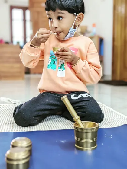 There's immense pride in doing things for yourself. This child is enjoying a snack she prepared all on her own using a mortar and pestle, a perfect example of our practical life skills activities.