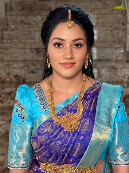 A smiling portrait that shows off the client's natural glow, enhanced by soft makeup.
