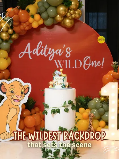 The wildest backdrop that sets the scene. This circular backdrop with a bold red, orange, and green balloon arch and a Simba cutout was the perfect centerpiece for Aditya's "Wild One" party.