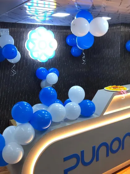 The reception desk at Punon Technologies, decorated with balloon clusters and a small Ganesha idol for an auspicious beginning.
