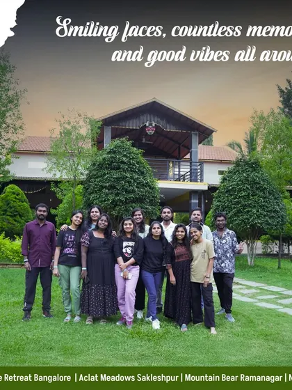 A large group poses in front of our Mountain Bear resort building. Our spacious properties can easily accommodate big groups for any occasion.