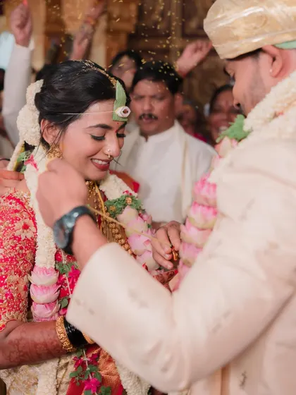 A candid moment from the wedding ceremony. Even in the midst of rituals, the bride's makeup stays perfectly in place, ensuring she looks her best in every photo.