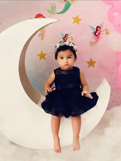 Sitting on the moon, surrounded by fairies and stars. This celestial theme is pure magic and creates a dreamy, enchanting portrait for your little one.