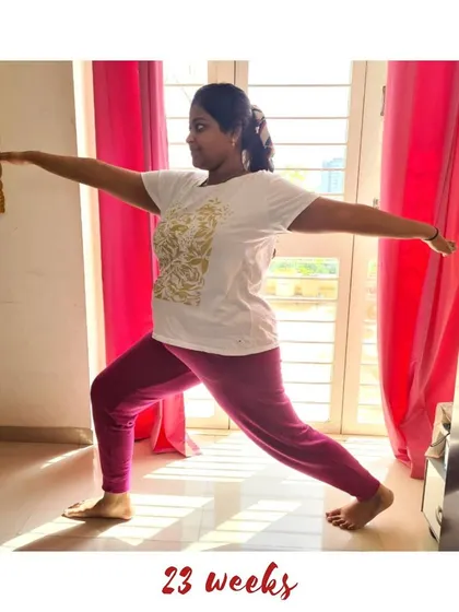 A powerful Warrior II pose (Virabhadrasana II) at 23 weeks, building strength and confidence.
