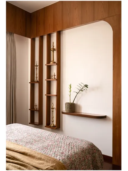 On the opposite wall of the guest bedroom, we designed custom vertical wooden shelves to display traditional brass lamps, adding a touch of heritage.