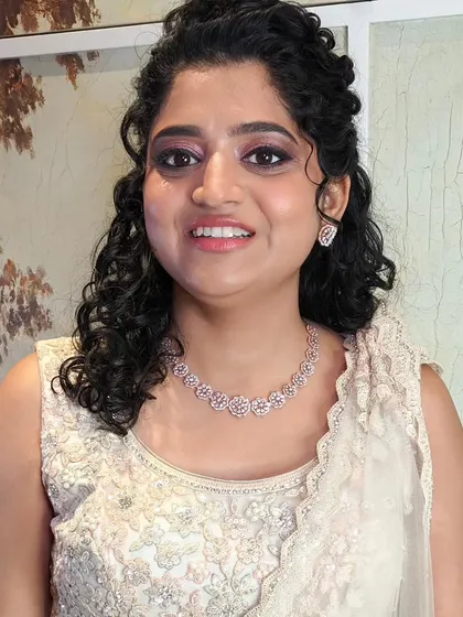 The bride is glowing and happy. Her reception look is soft, romantic, and lets her natural beauty shine.
