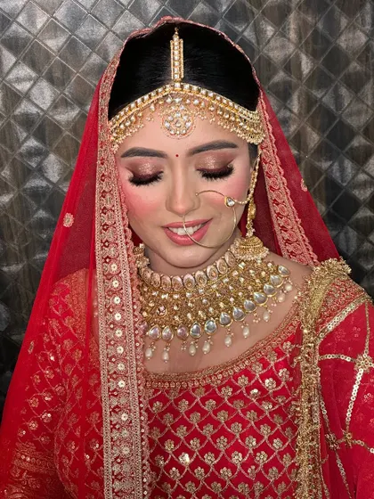 Another angle showing the soft smile of a happy bride. The makeup is designed to look beautiful both in pictures and in person.