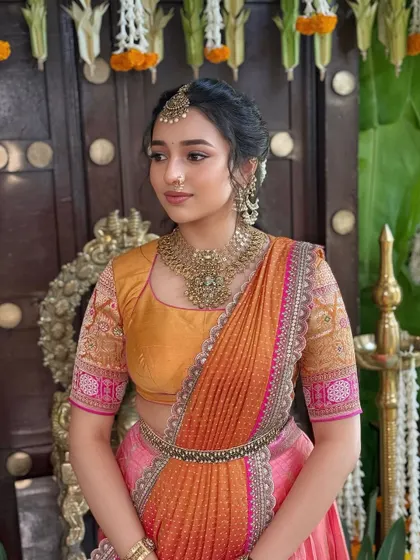 A side profile capturing the grace of this traditional look. The soft makeup and braided hairstyle are perfect for a pre-wedding pooja.