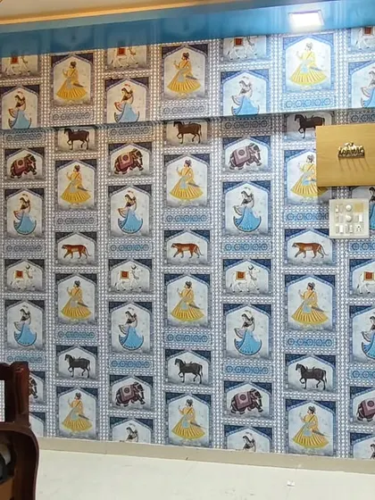 A repeating pattern wallpaper featuring Indian motifs of women, horses, and elephants, installed in Nalasopara. This design adds a quirky and traditional touch to the room.