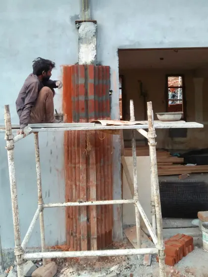A duplicate image showing the meticulous work involved in the brick application.