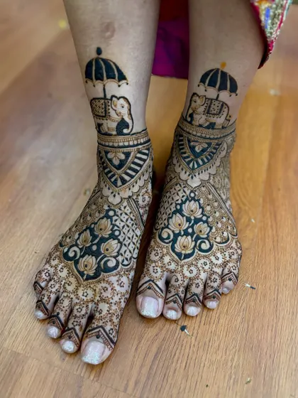 A unique bridal feet design featuring elephants under umbrellas, a playful and royal motif.