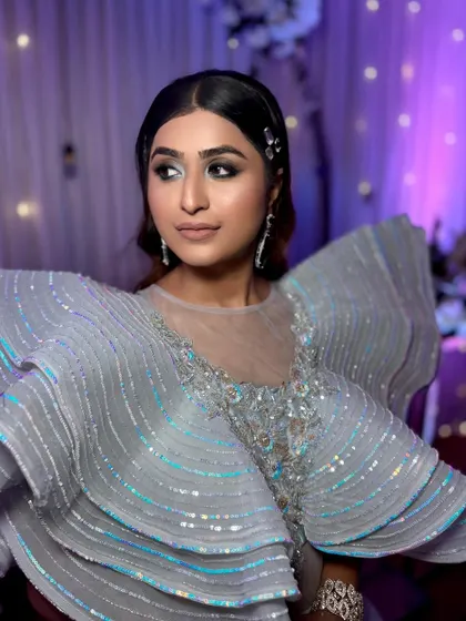 Glammed up for a perfect cocktail night. This look features a dramatic, structured gown paired with equally bold and beautiful makeup.